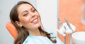 Woman in dental chair with lovely smile