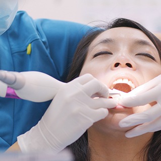 A woman getting scaling and root planing treatment