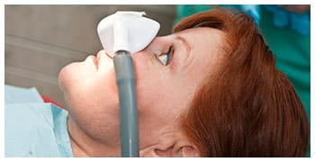 Woman with nitrous oxide sedation mask