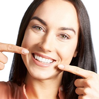Woman pointing to her teeth