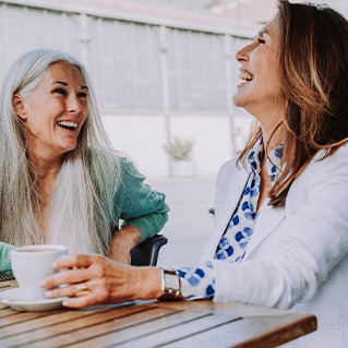 Two senior woman enjoying coffee together