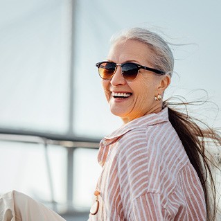 Senior woman smiling while relaxing on boat