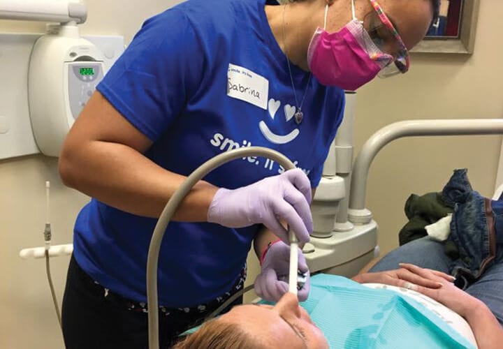 Sabrina working with dental patient