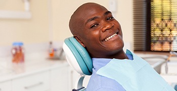 man smiling after getting treatment for his dental emergency in Tallahassee