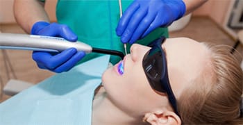 A young patient receiving a dental filling.