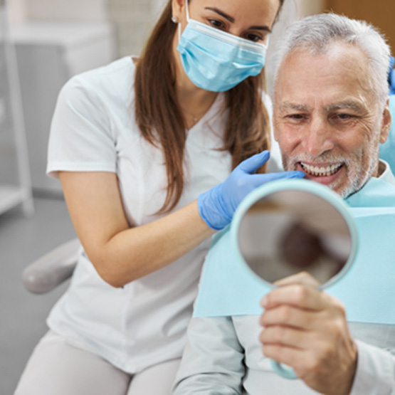 An aging gentleman happy with his new dental implants