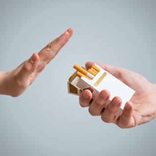 A hand refusing the offer of cigarettes