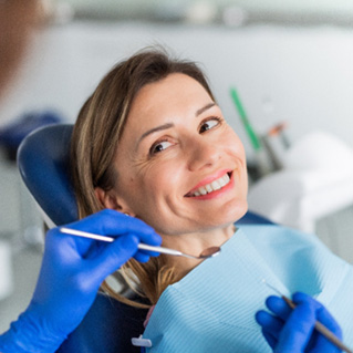 A woman receiving a dental checkup from her dentist