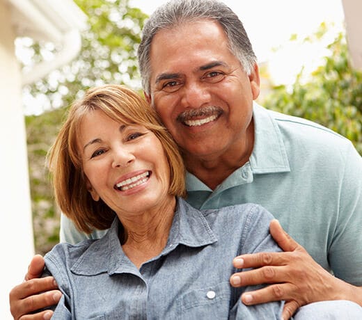 Older couple with healthy happy smiles