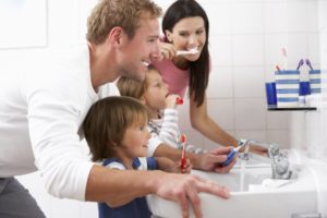 family brushing teeth