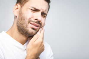 Man in white shirt who needs emergency dentist in Tallahassee