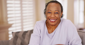 Woman smiles with dental implants and jaw preservation