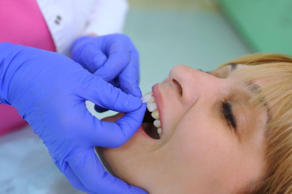 A woman having veneers applied by her dentist